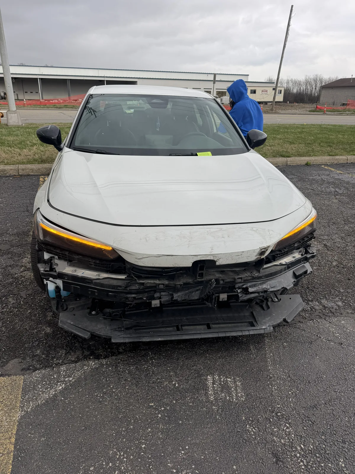 White Honda Civic with front bumper removed after collision