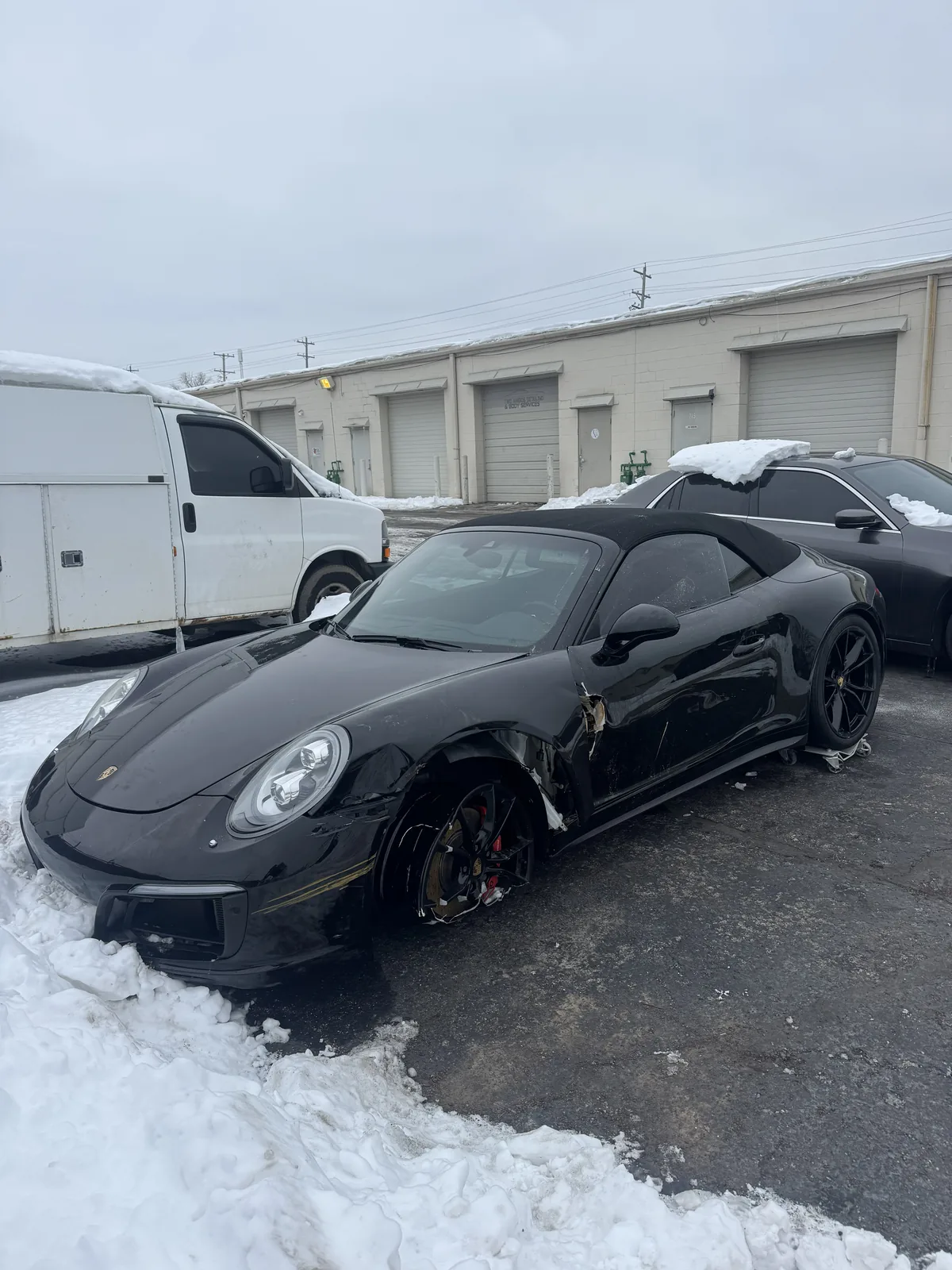 Black Porsche 911 cabriolet at the shop
